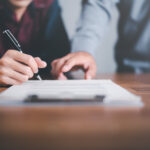 businessman pointing and signing a business agreement,concept pr